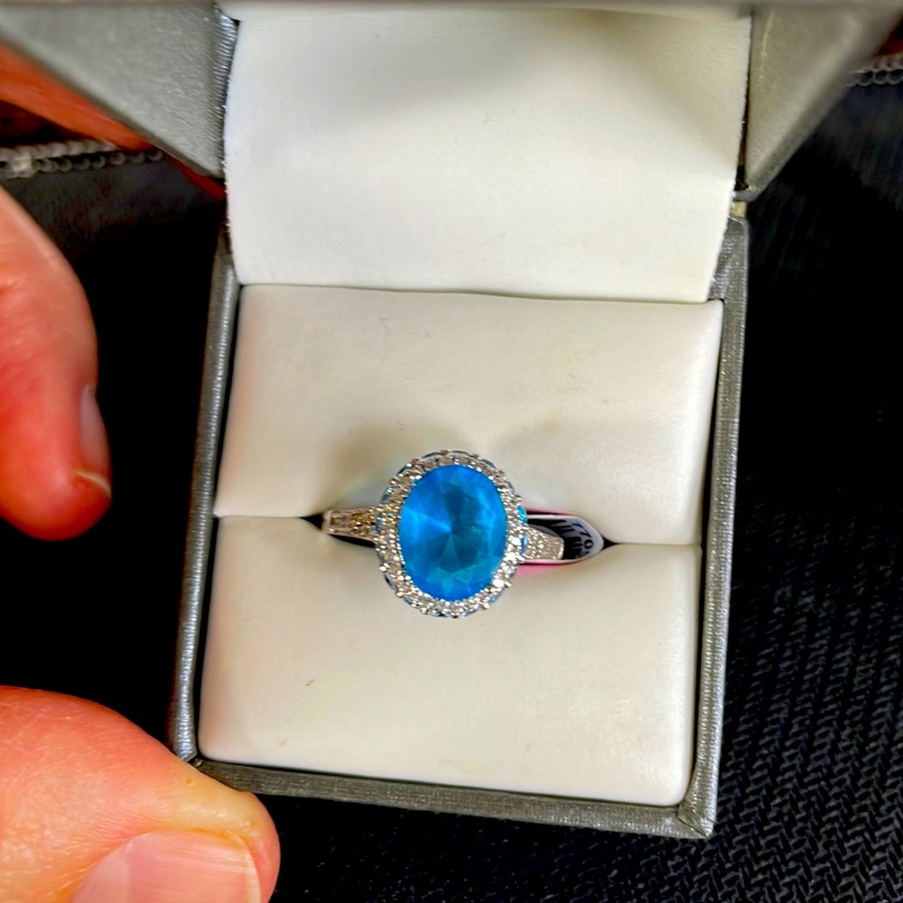 Oval simulated blue topaz.
